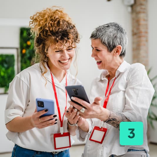 3 - two colleagues smiling together comparing health plans