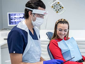 Patient and dentist looking at tablet