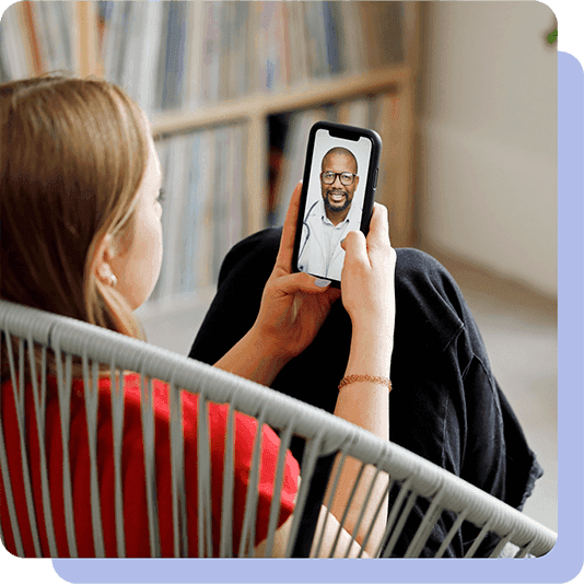 Lady sat in chair having mobile gp video call