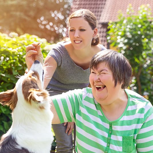 two-women-stroking-dog