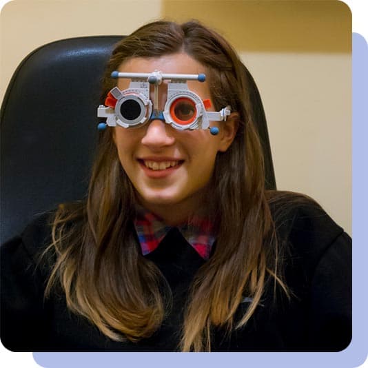 Woman doing a snellen test at the opticians
