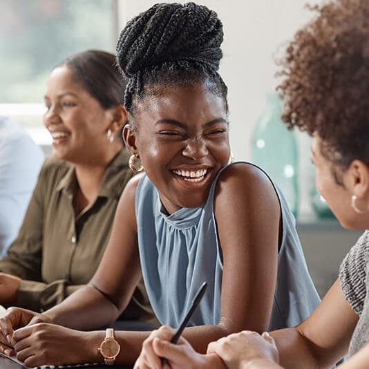 Lady smiling to colleague next to her