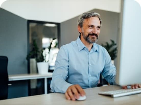 Smiling man working at a computer hub