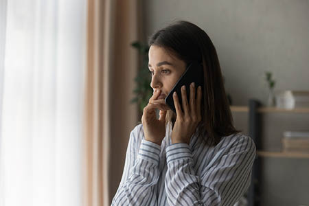 Woman looking concerned whilst on phone call