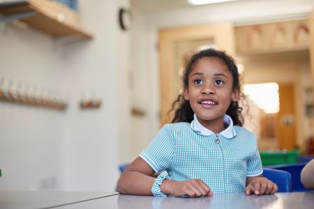 Young girl smiling in school classroom