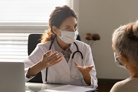 A female GP having an in-person appointment with a patient