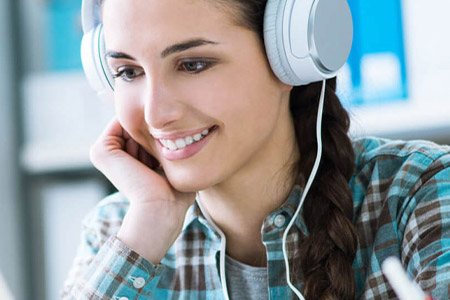 Woman smiling whilst wearing headphones
