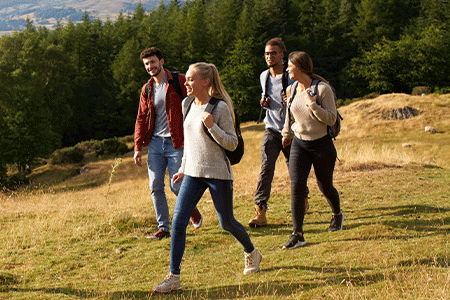 Group of friends walking on a hillside