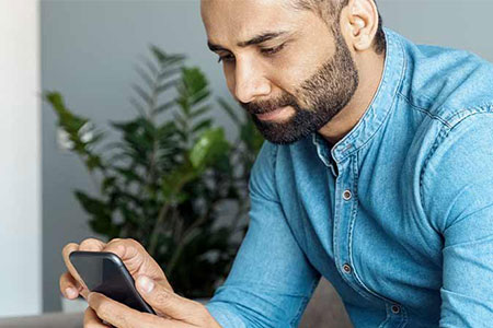 Man logging on to online GP doctor appointment on smart phone