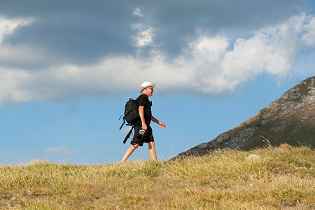 Man hiking across hillside