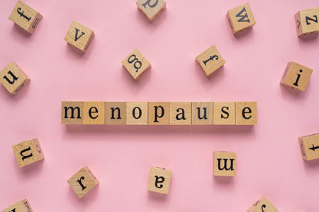 The word 'menopause' spelled out in wooden letters
