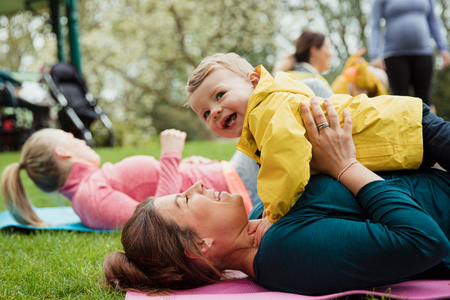 A mother and her child doing exercises in the park