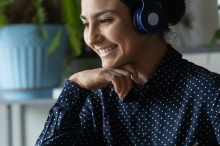 Woman smiling at laptop screen