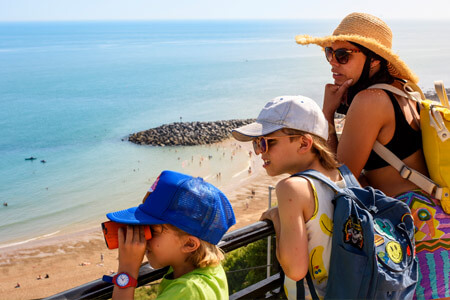 Family looking down over sweeping beach coastline