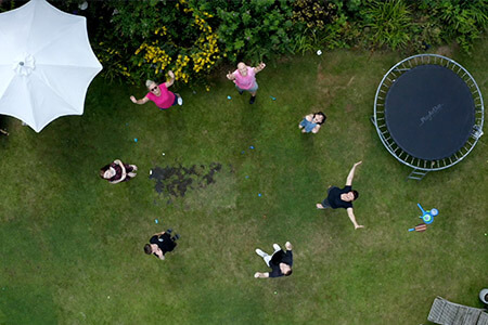 Drone shot of Heather Fisher and family in garden