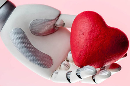 Robotic hand holding a toy heart