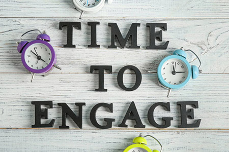 The words 'TIME TO ENGAGE' surrounded by alarm clocks