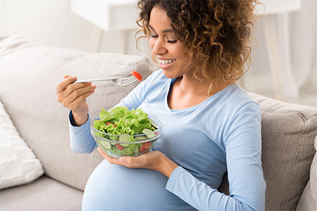 Pregnant lady eating healthy salad