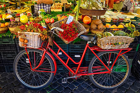 Bicycle in front of fruit and vegetables market stall