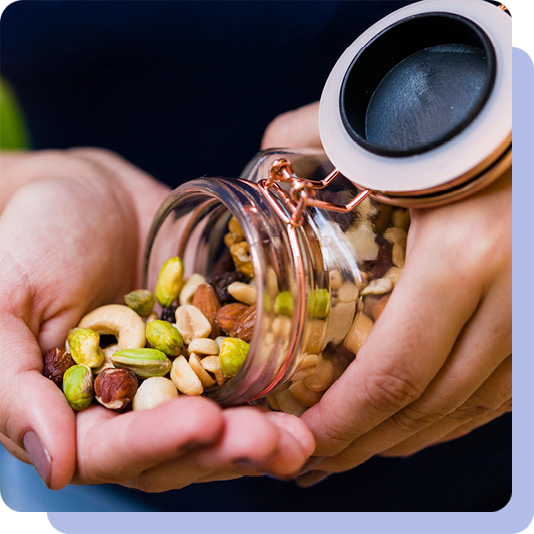 Person pouring mixed nuts out of a jar