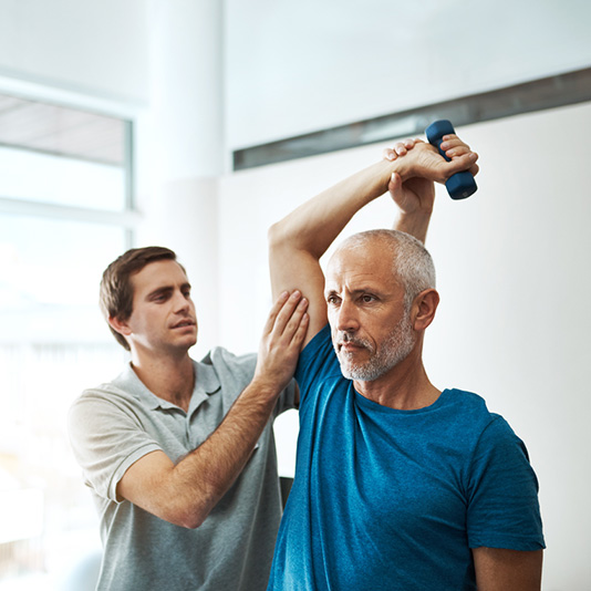Man stretching his arm at physio appointment