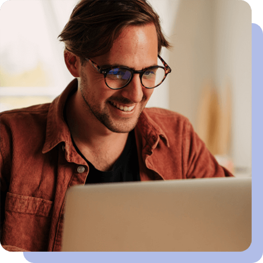 Man wearing glasses using his laptop