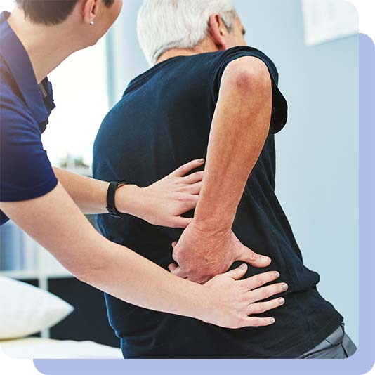 Osteopath reviewing a patient's lower back
