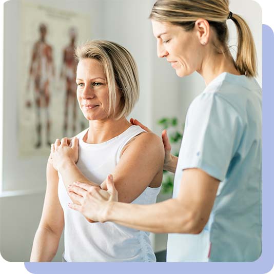 physiotherapist looking at patients arm and shoulder movement