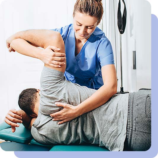 Physiotherapist holding patient's arm up to feel the muscle movement in their back