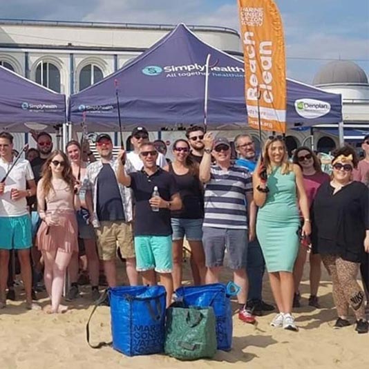 Simplyhealth employees during a beach clean on Bournemouth beach