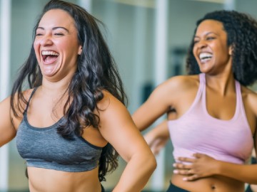 Two ladies enjoying an indoor exercise class