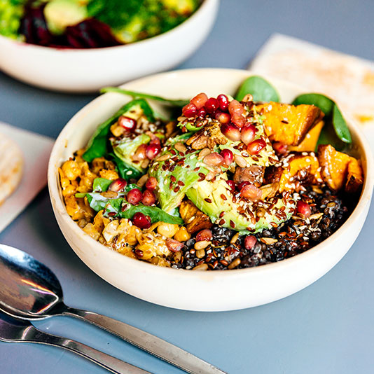 A bowl full of vegetables, lentils and grains