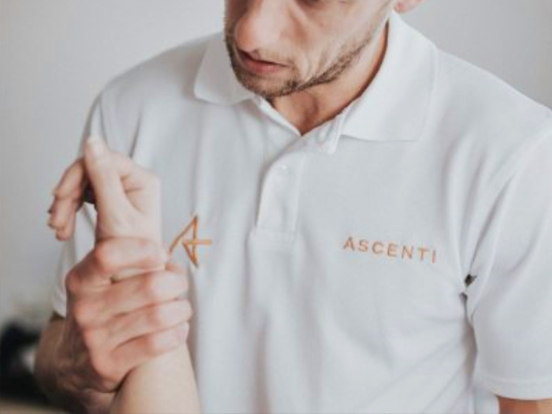 Ascenti physiotherapist holding a person's wrist