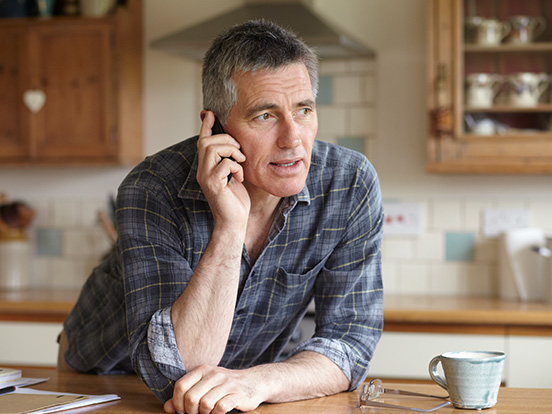 Man having phone call in his kitchen