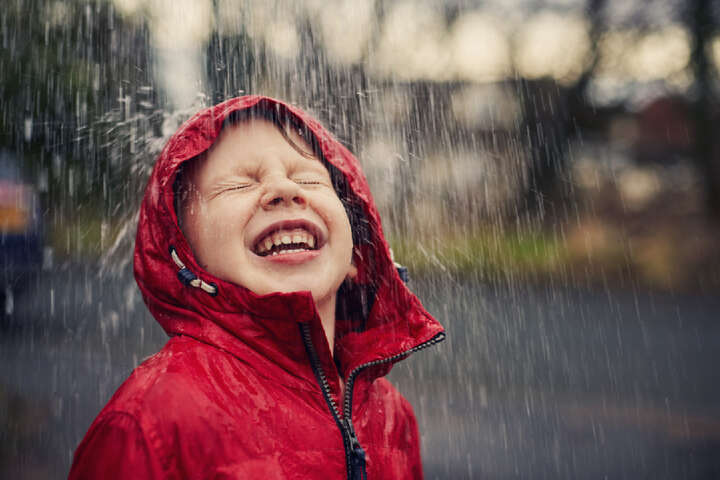 Child laughing in the rain