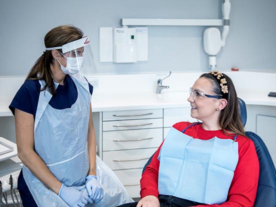 A patient discusses treatment options with her dentist