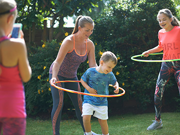 Mother hula hooping with son