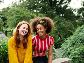 Two teenage girls laughing together