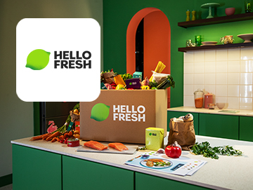 Hello Fresh logo on image of box with ingredients on kitchen worktop