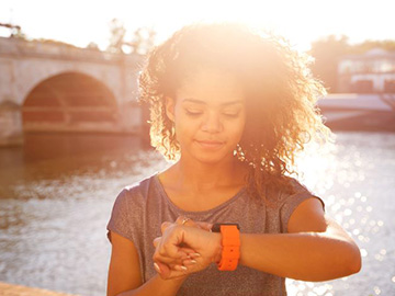 Woman exercising and checking her smart watch