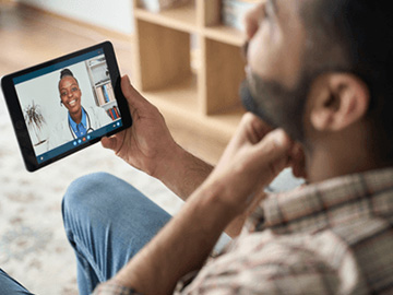 Man having video call with gp on tablet