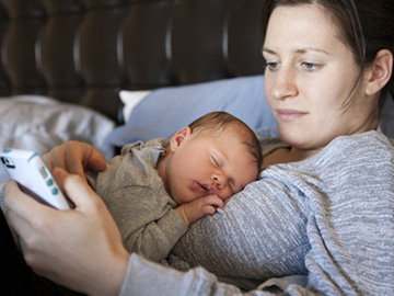 Woman with sleeping baby on her chest