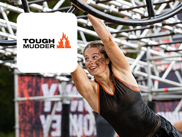 Tough Mudder logo on image of woman hanging from obstacle