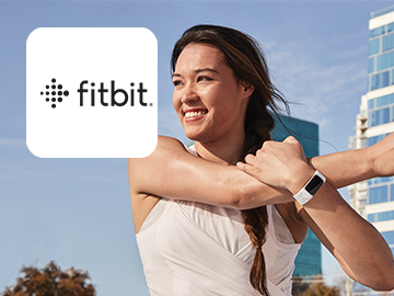 Fitbit logo on image of woman wearing Fitbit and stretching after exercise