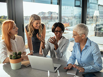 Women having a meeting at laptop in a office