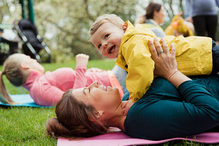 Mother and toddler yoga class in a park